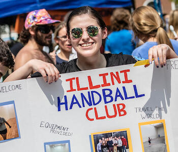 student holding handball club sign